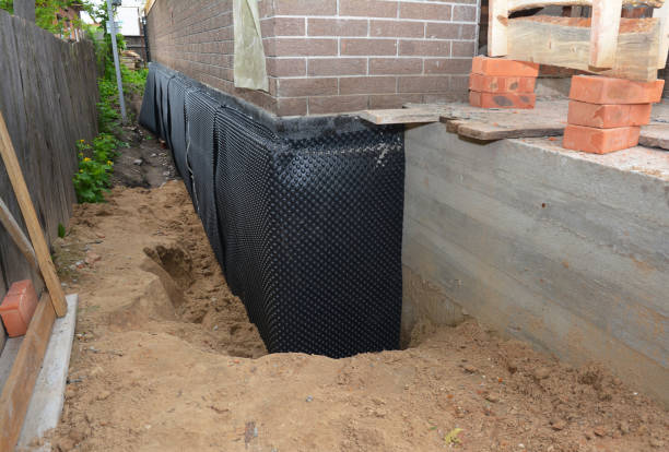SJ Waterproofing Pros technician performing targeted Vapor Barrier Installation assessment in Trufant, MI